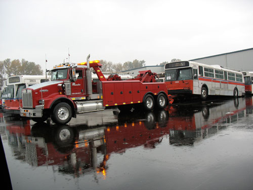 A tow-truck gets ready to haul a trolley away.
