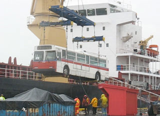 A trolley being hoisted into the cargo hold of a ship bound for South America.