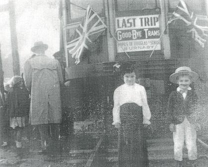 Two children stand in front of the Burnaby Lake Interurban car, just prior to its last run through Burnaby in 1953. The boy has been identified as Grant Washington. A sign attached to the car reads: "Last trip, good-bye trams, Pupils of Douglas School, Burnaby." (Item 431-001, from the Burnaby Historical Society Community Archives Collection, courtesy of the City of Burnaby Archives.)