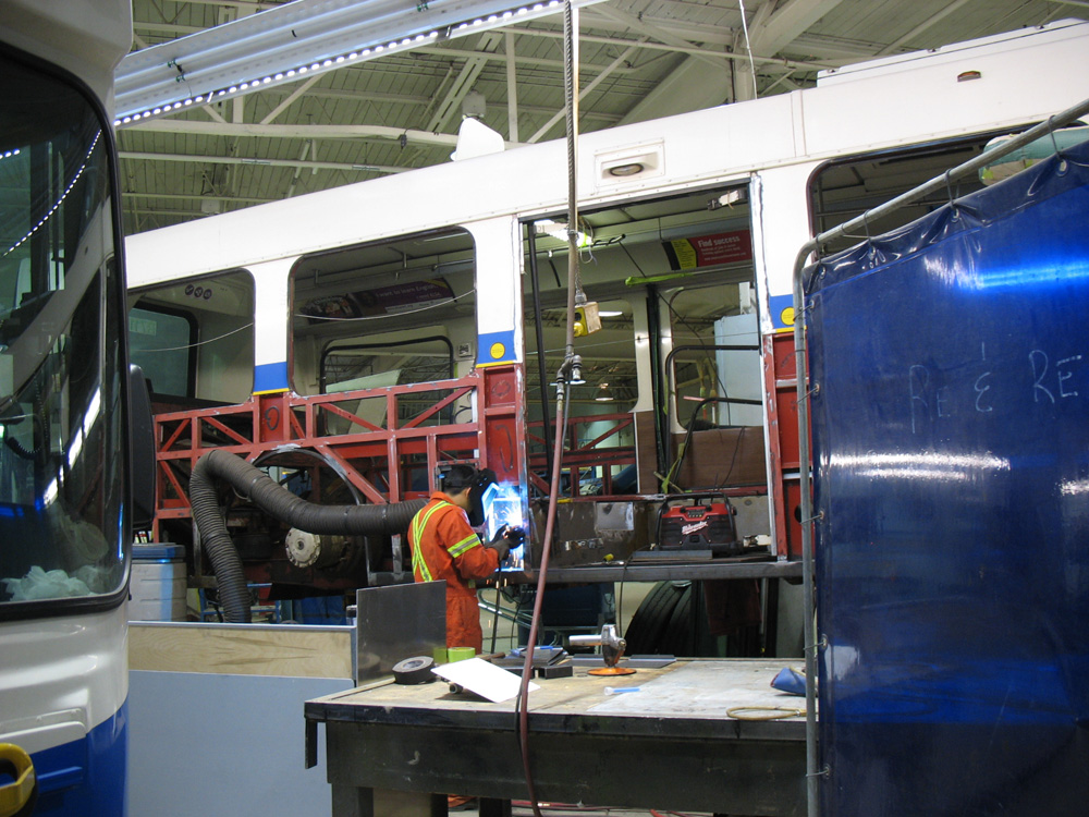 Here’s a conventional bus undergoing an overhaul. Welding is being done on the frame to repair a rusted-out element. The red colouring is existing rustproofing provided by the manufacturer.