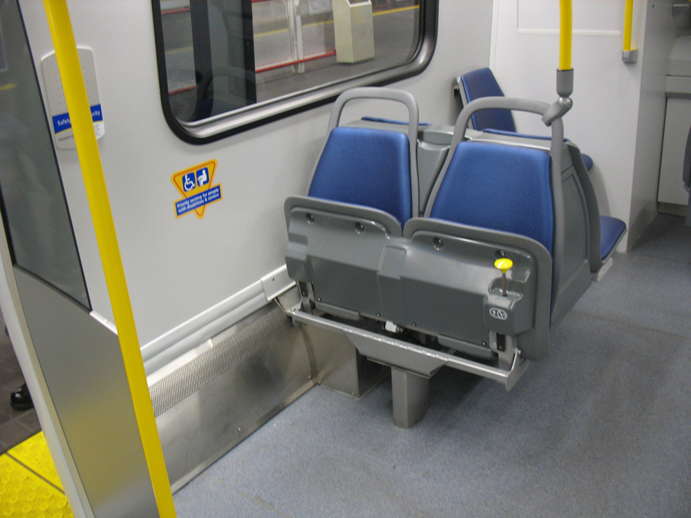 These seats on the train fold up to allow room for wheelchairs and strollers.