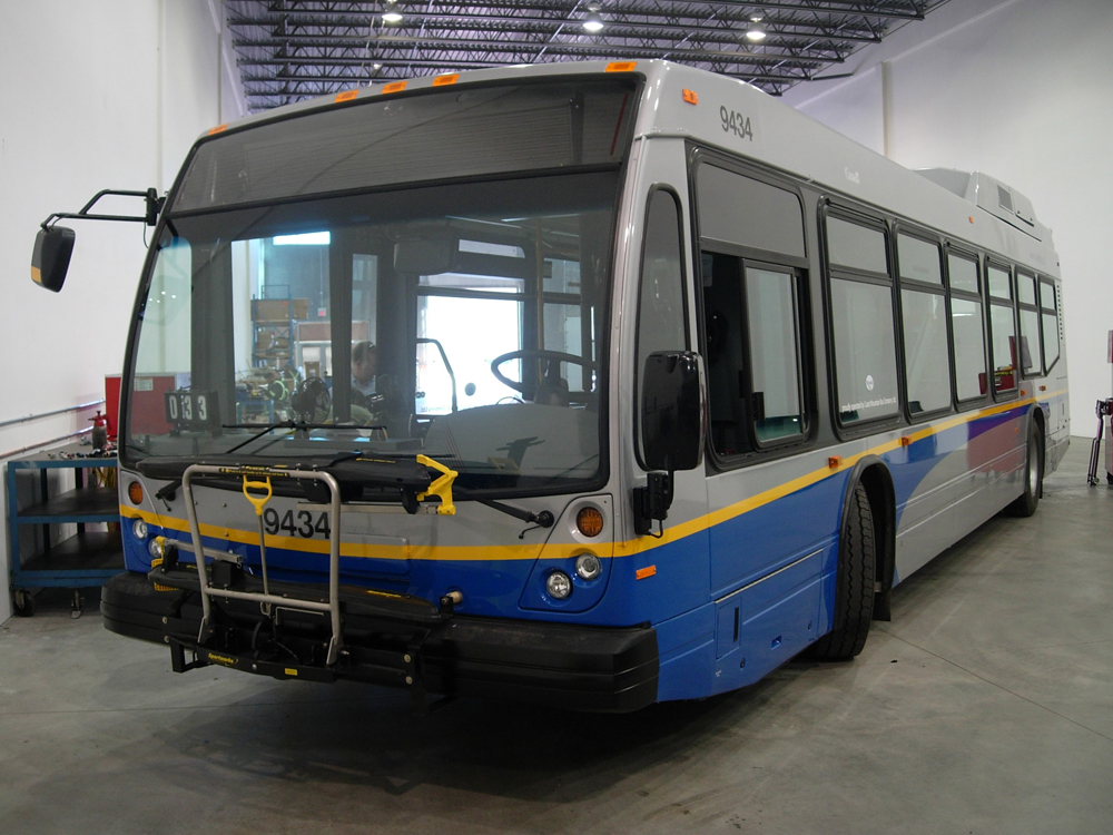 A Nova hybrid bus at the garage, being inspected and tuned up after arriving from the manufacturer.