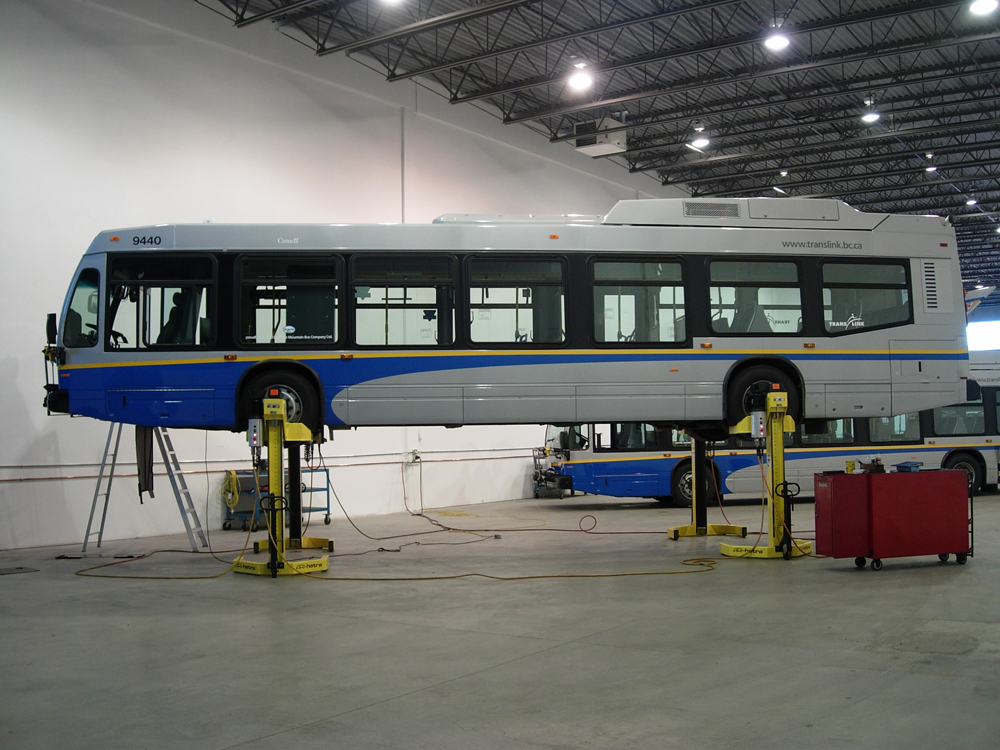 A Nova hybrid bus up on hoists at the garage!