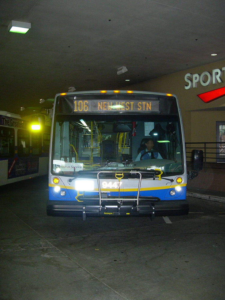 A Nova hybrid on the 130 route, parked at Metrotown Station loop. You can see the arched stanchions inside!