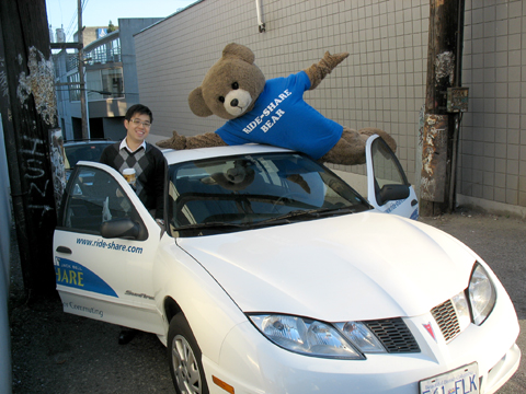 The Ride-Share bear with a ridesharing buddy in one of the Jack Bell Ride-Share cars! (They provide cars for your carpool, free!)