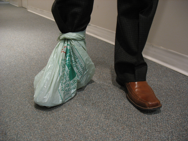 Plastic bags can be used to cover your shoes in a pinch. Wrap the handles of the bag around your ankle and secure it with an elastic band.
