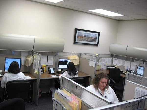 Reviewers at the Quickpass office examine license plate photos flagged by the system.