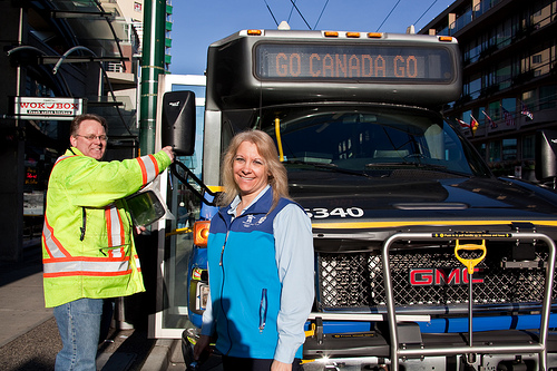 Gord replacing a mirror for Mary, Community Shuttle Operator 