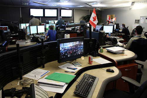 A monitor on one desk displays a live-cam from downtown Vancouver, so T-Comm can monitor the movements of crowds.