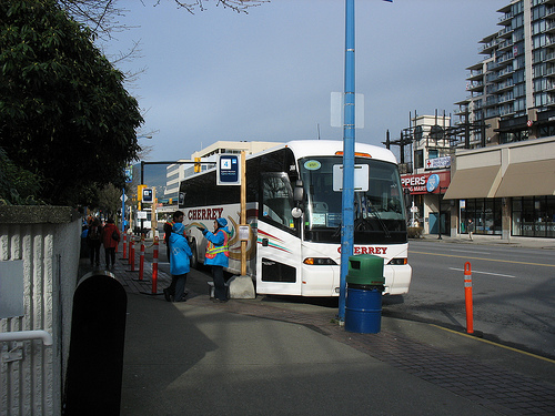 An Olympic bus parked at the departure hub at Lonsdale Quay.