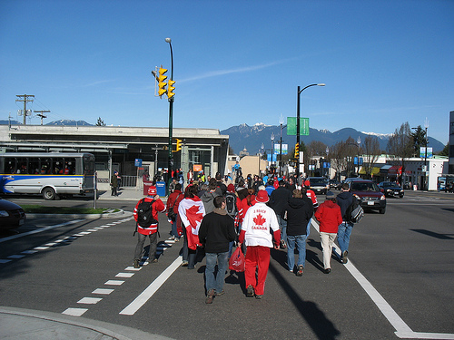 A crowd emerges from the curling venue and heads for King Edward Station on the Canada Line.
