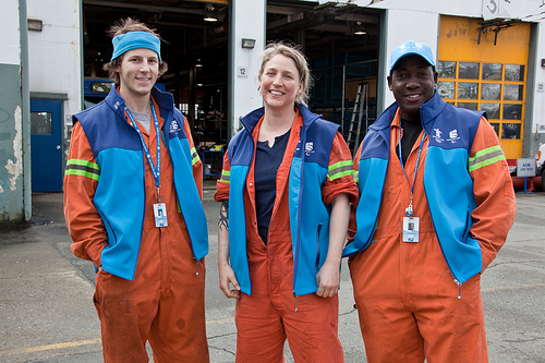 OTC SWT mechanics Marie, Curtis, and Omar in their Olympic gear. Photo by Charlotte Boychuk.