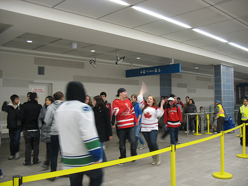 Happy people coming off the Canada Line at Vancouver City Centre.