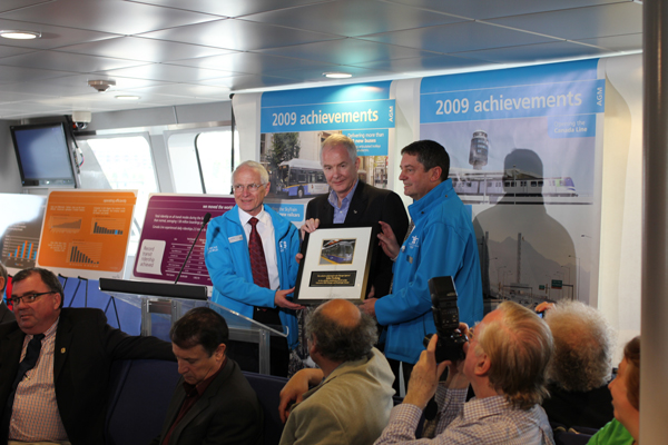 John Furlong, head of the Vancouver Olympic Organizing Committee, receives a plaque from Dale Parker and Ian Jarvis!  