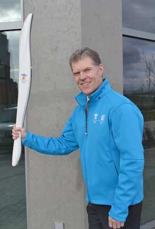 Mike with his souvenir torch and TransLink staff official Winter Olympic jacket