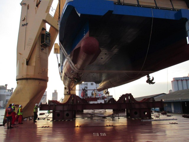 Then, she gets lowered onto the cargo ship