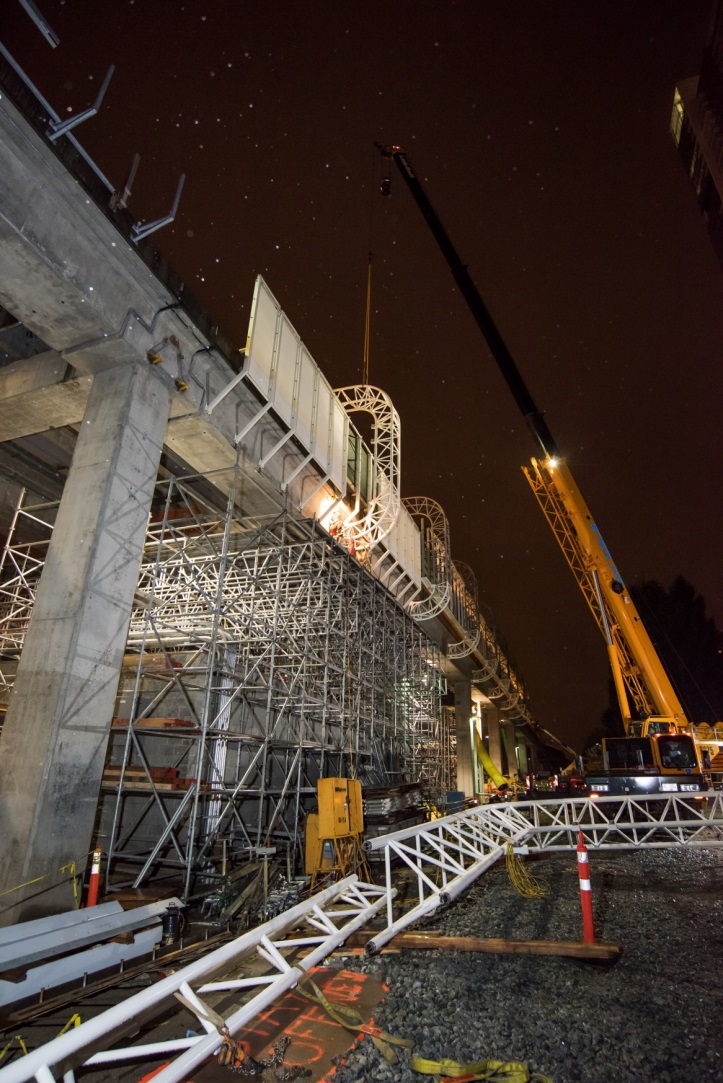 Hoop truss being secured to station.