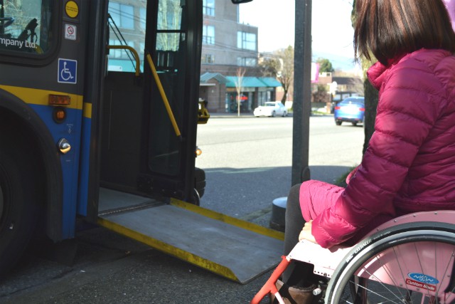 Customer using wheelchair getting on the bus