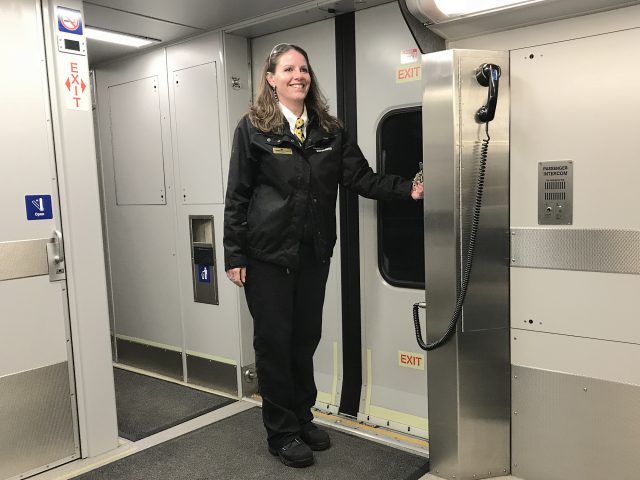 Leanna Turcotte, Train Conductor for West Coast Express stands on passenger train