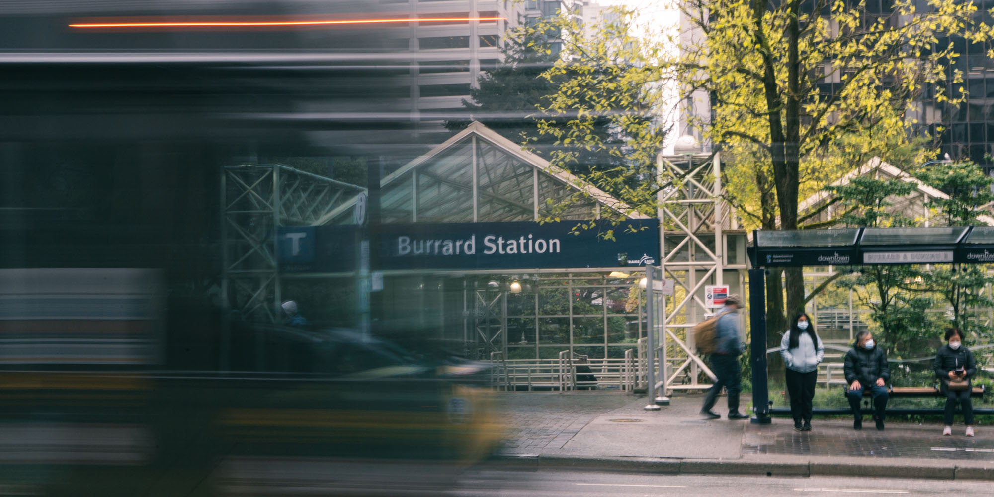 A bus drives by the entrance to Burrard Station
