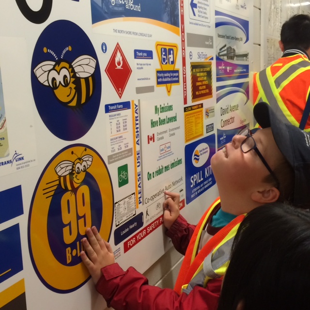 Joshua checks out the many signs made at Burnaby Transit Centre!