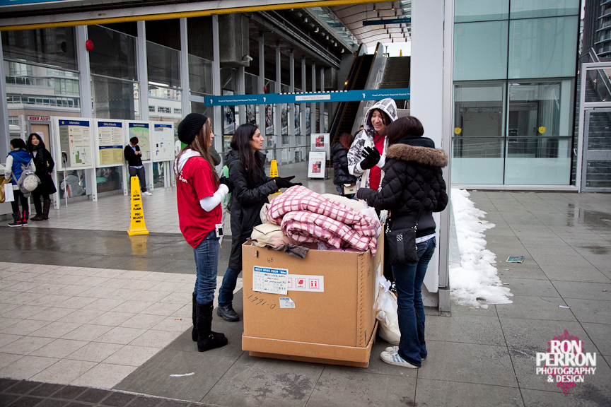 Volunteers—or "blanketeers"—collect blankets outside a Canada Line station as part of the "Drive on the Line."