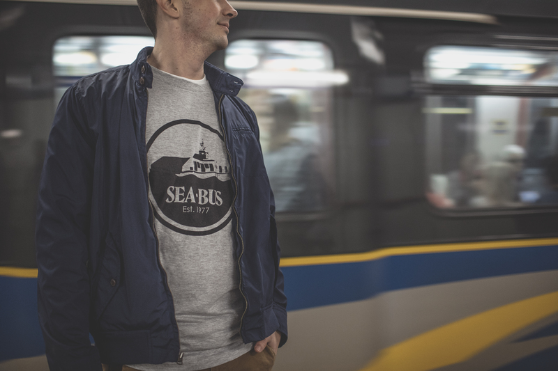 Grey SeaBus shirt in front of SkyTrain