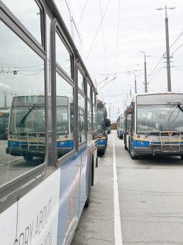 Photo of buses reflecting image of other buses parked at Vancouver Transit Centre