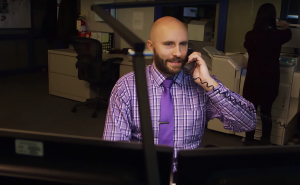 Derek Zabel talking on the phone at CMBC office, 2015