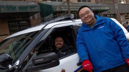 Transit Police and TransLink staff pose outside police cruiser at Lunar New Year parade