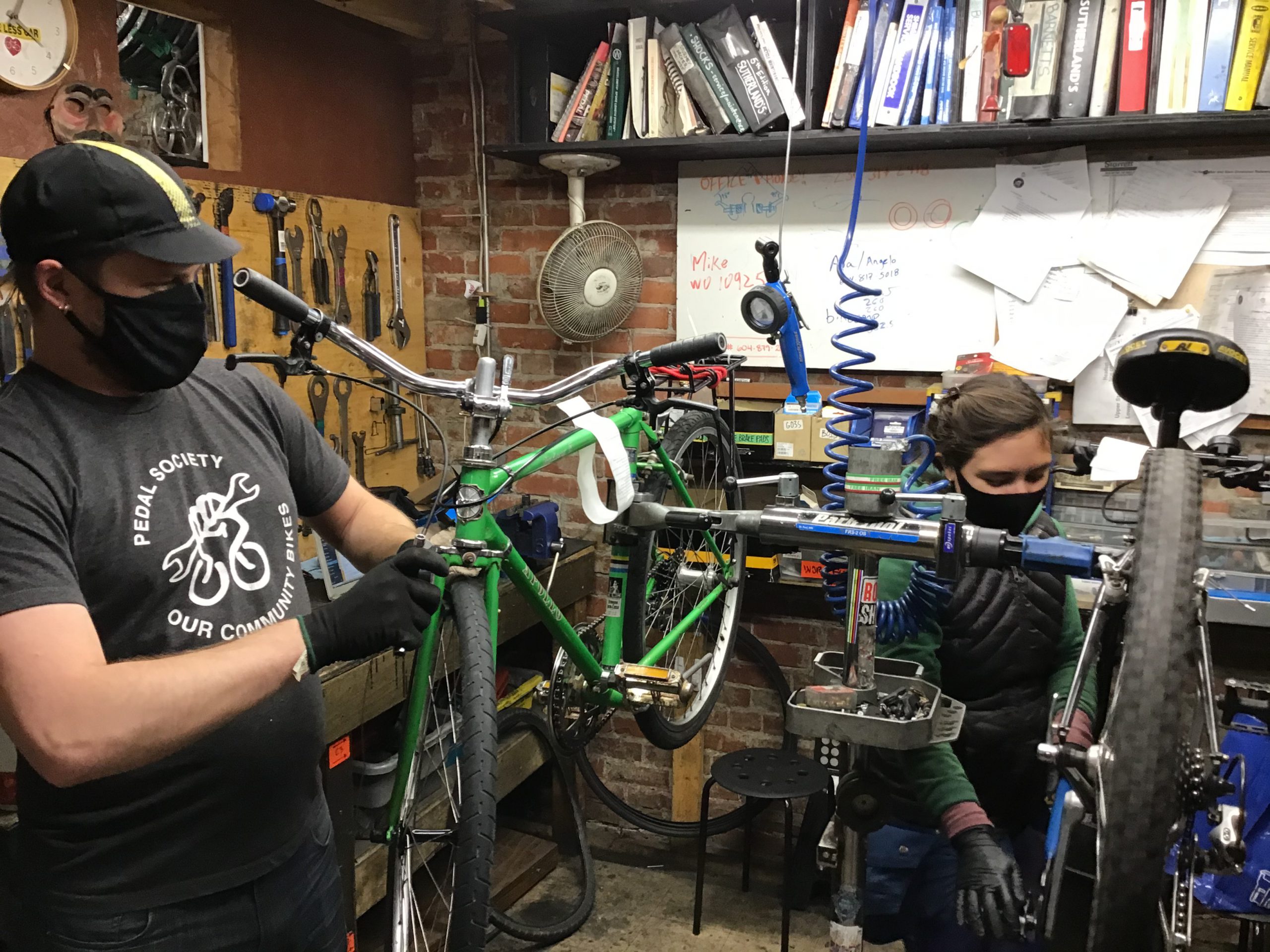 A person refurbishes a bike at Our Community Bikes.