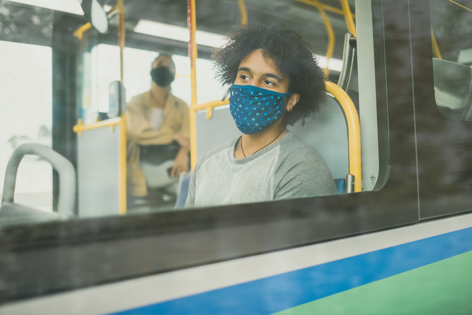A person with a mask on riding the RapidBus