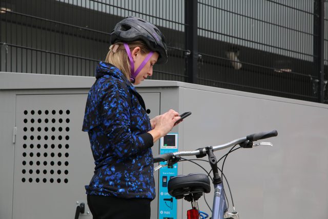 woman using on-demand bike locker