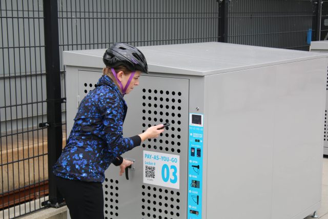 woman closing on-demand bike locker