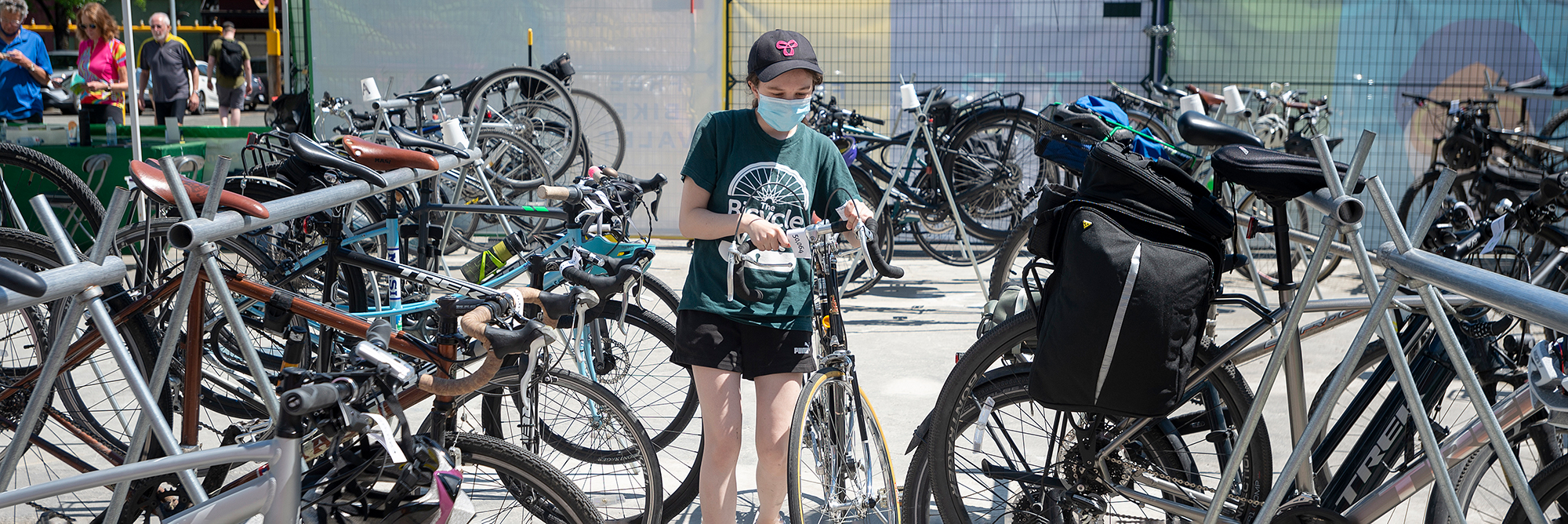 A Bike Valet volunteer parks a bike