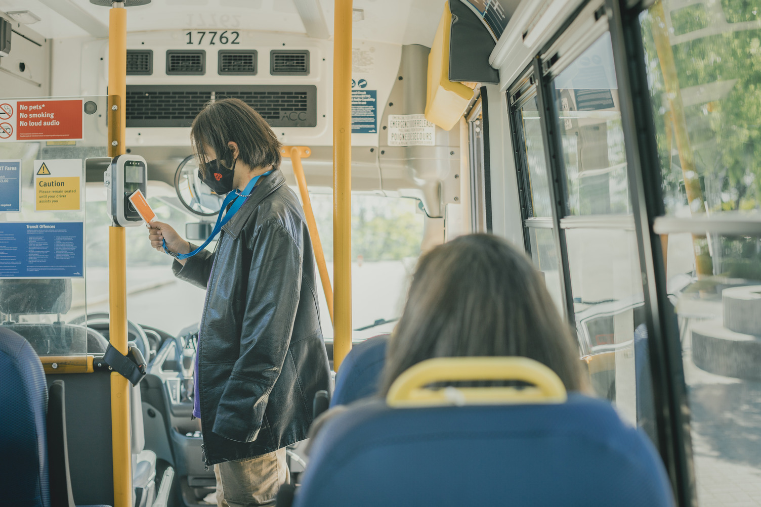 Customer taps their concession Compass Card on the HandyDART bus