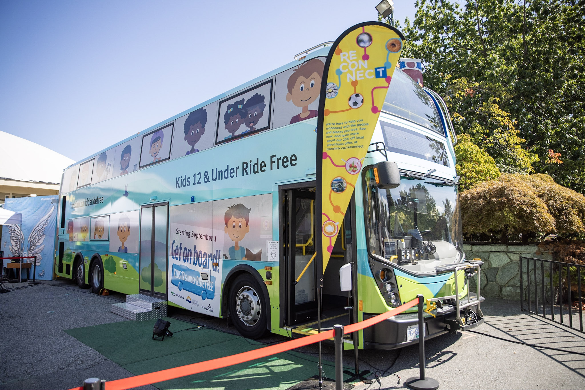 A double decker bus is seen wrapped in a campaign ad for Free Transit for children 12 and under