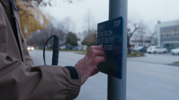 Rob Sleath feels bus stop braille sign in Richmond