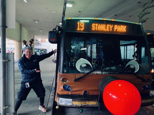 Bus operator Erika Jensen poses for a photo in front of the Reindeer Bus