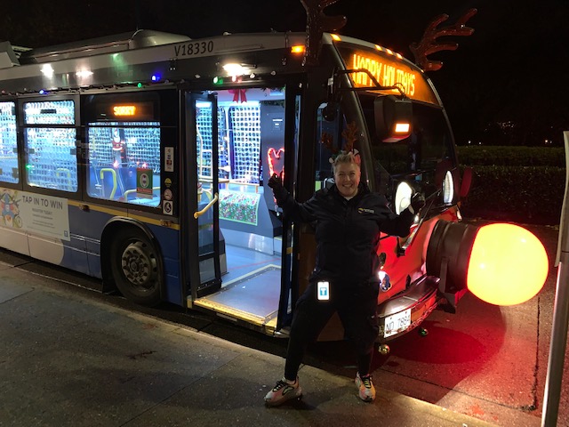 Bus operator Erika Jensen poses for a photo in front of the Reindeer Bus
