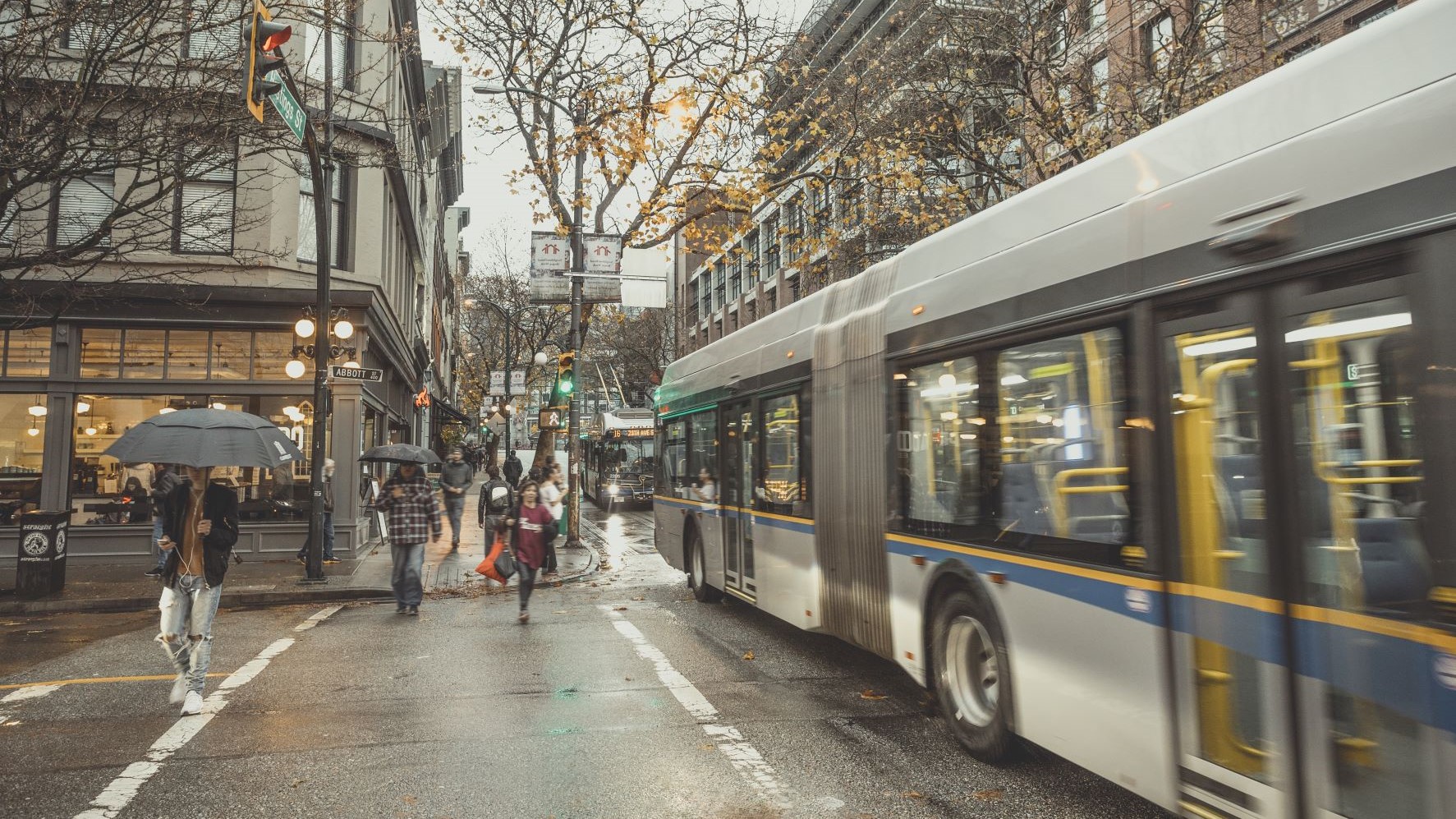 People walking along Hastings Street with bus passing by