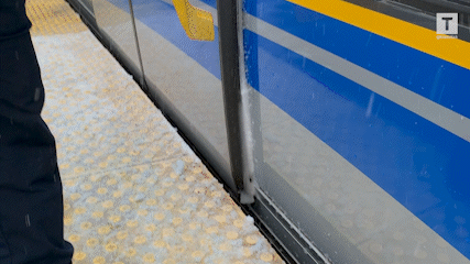 Snow and ice are cleared from the SkyTrain door