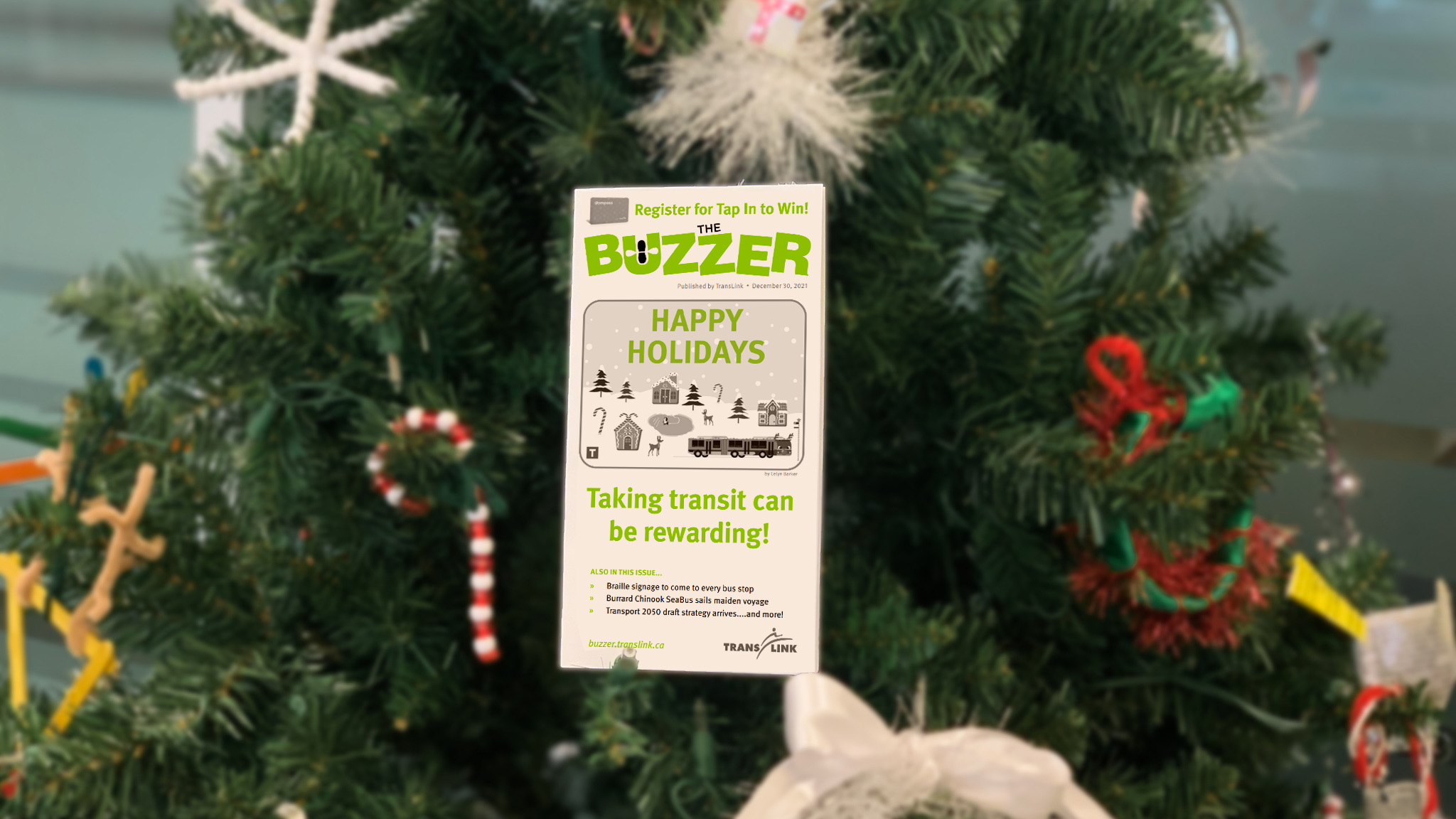 The December 2021 issue of The Buzzer resting on a Christmas tree