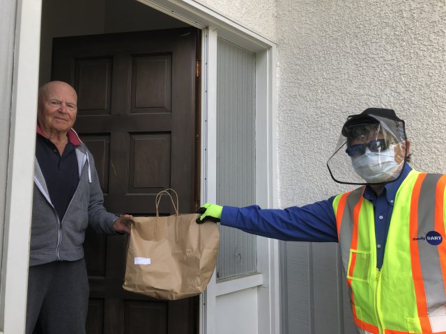 HandyDART operator delivers food from Cedar Cottage to HandyDART customer during COVID-19 epidemic