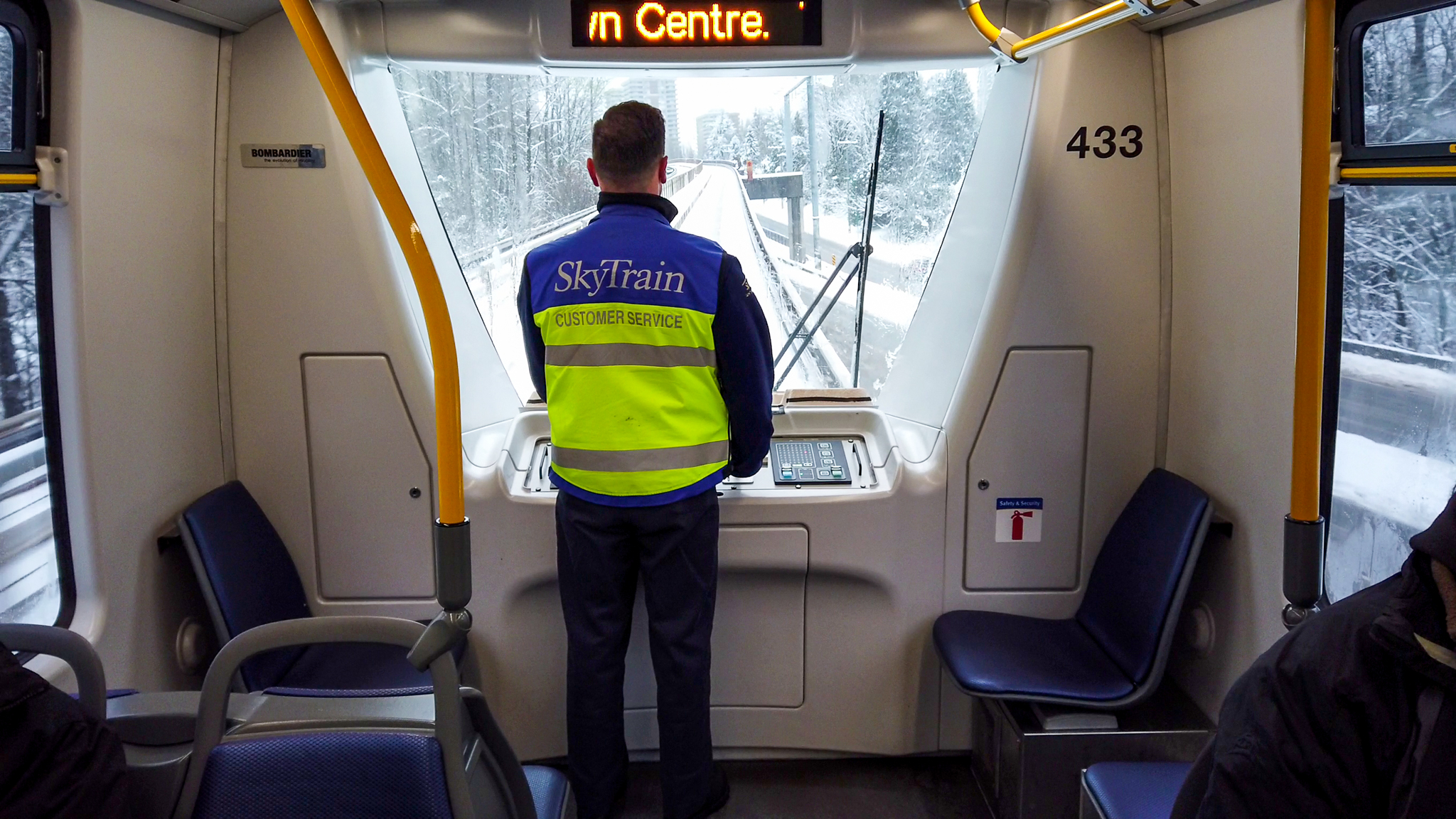 A SkyTrain Attendant monitoring the tracks as the train travels towards Lougheed Town Centre Station