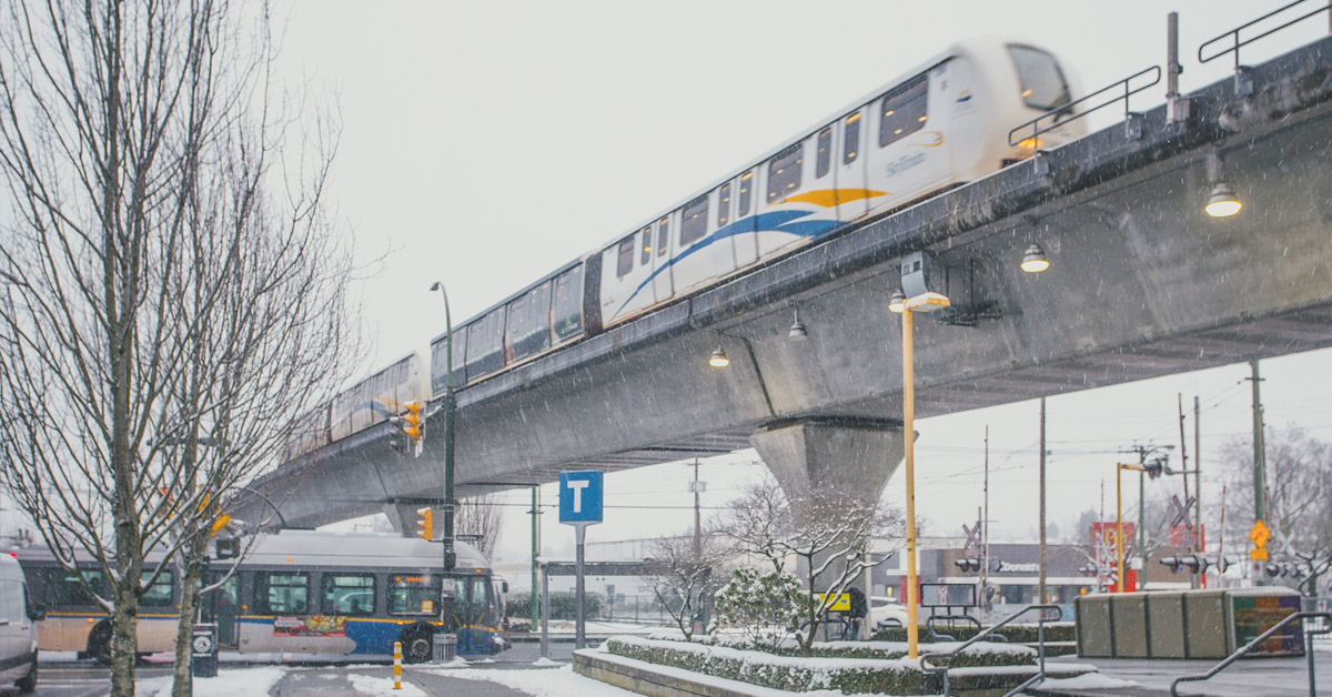 A four-car train operating on the Millennium Line during snowy weather