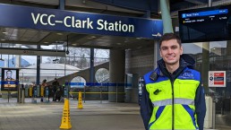 : SkyTrain Attendant Kyle Monda stands at the entrance of the VCC-Clark Station