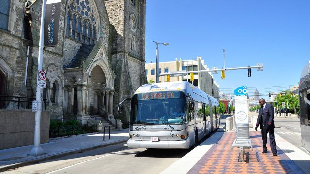 Bus Rapid Transit driving past a cathedral