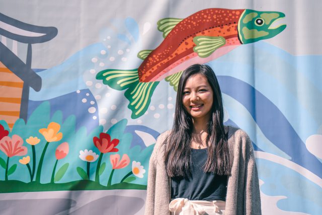 Artist Laura Kwok stands in front of her public art project at Capstan Station