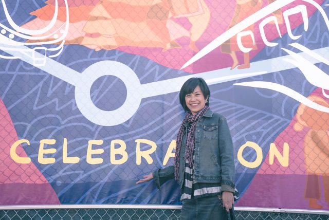 Artist Jeni Chen stands in front of her public art project at Capstan Station